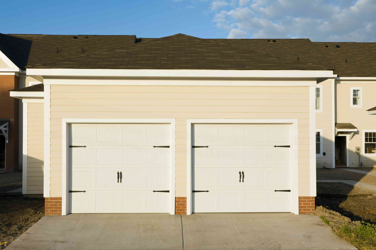 A technician performing maintenance on a residential garage door system